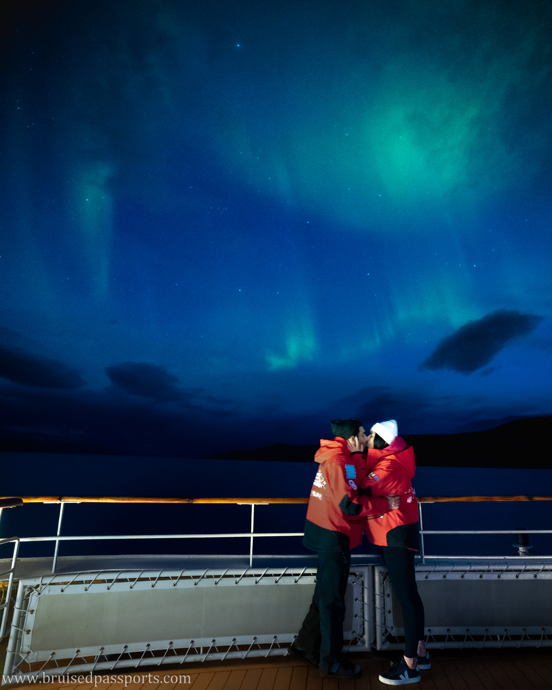 couple under northern lights in greenland canada on a cruise ship