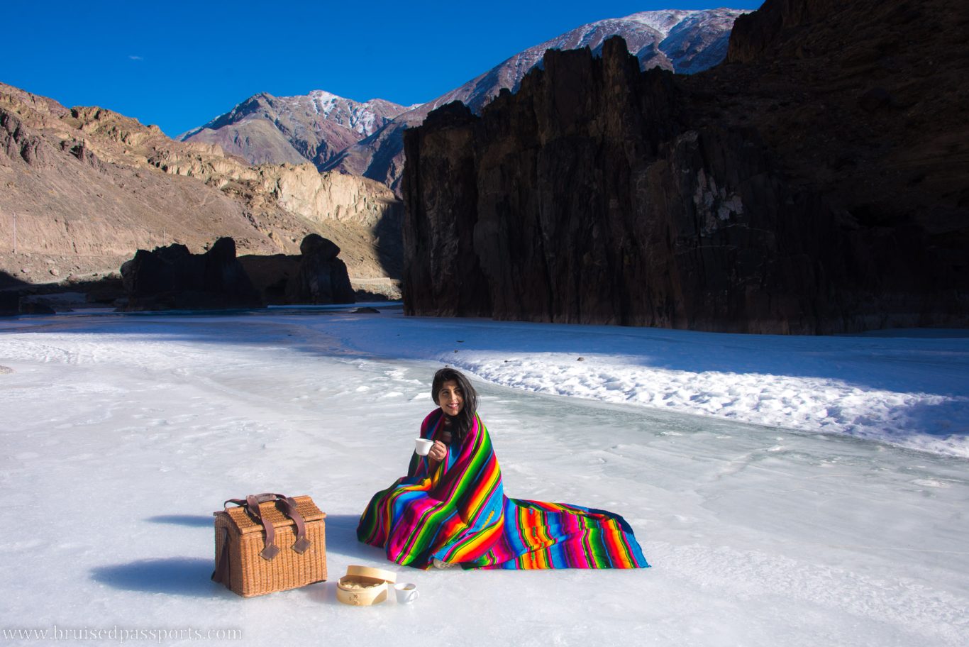 Girl picnicking on frozen Zanskar river in Ladakh India