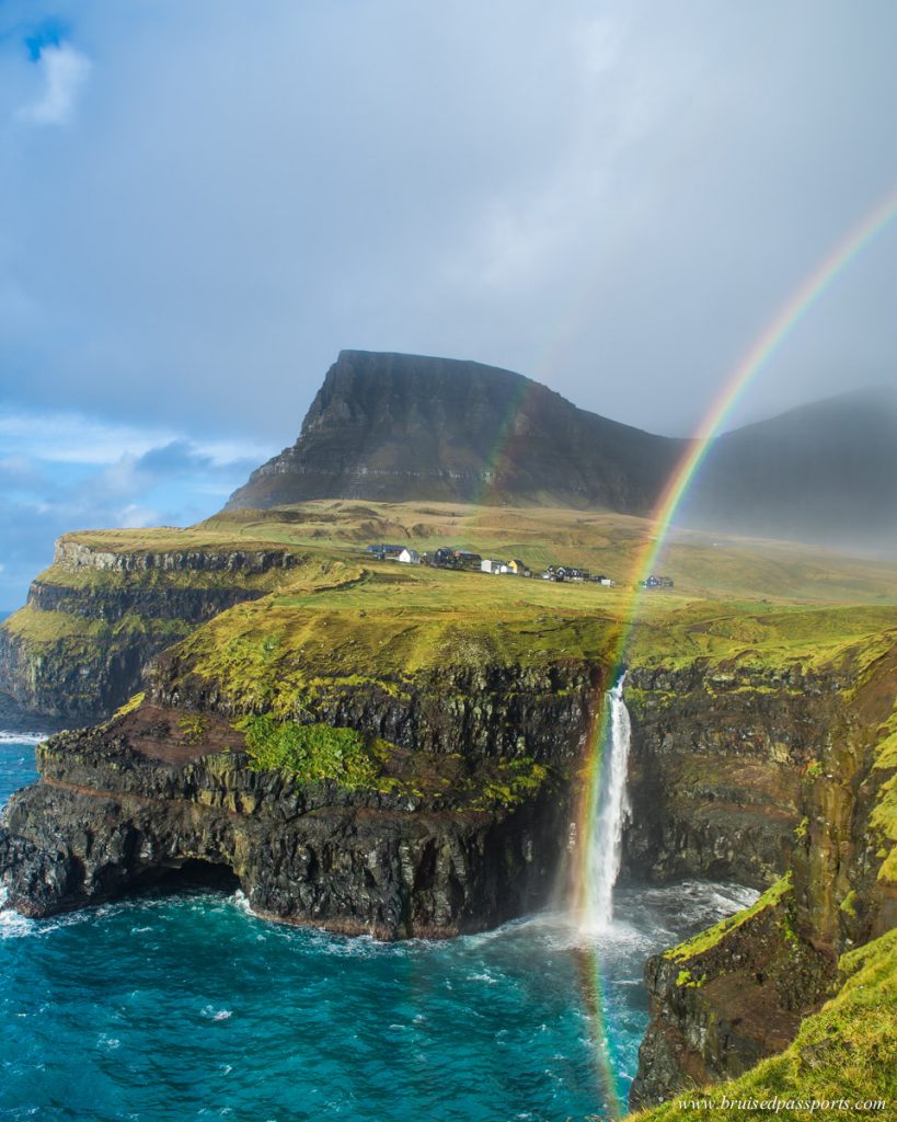 rainbow and waterfall under the village Gasadalur Faroe Islands