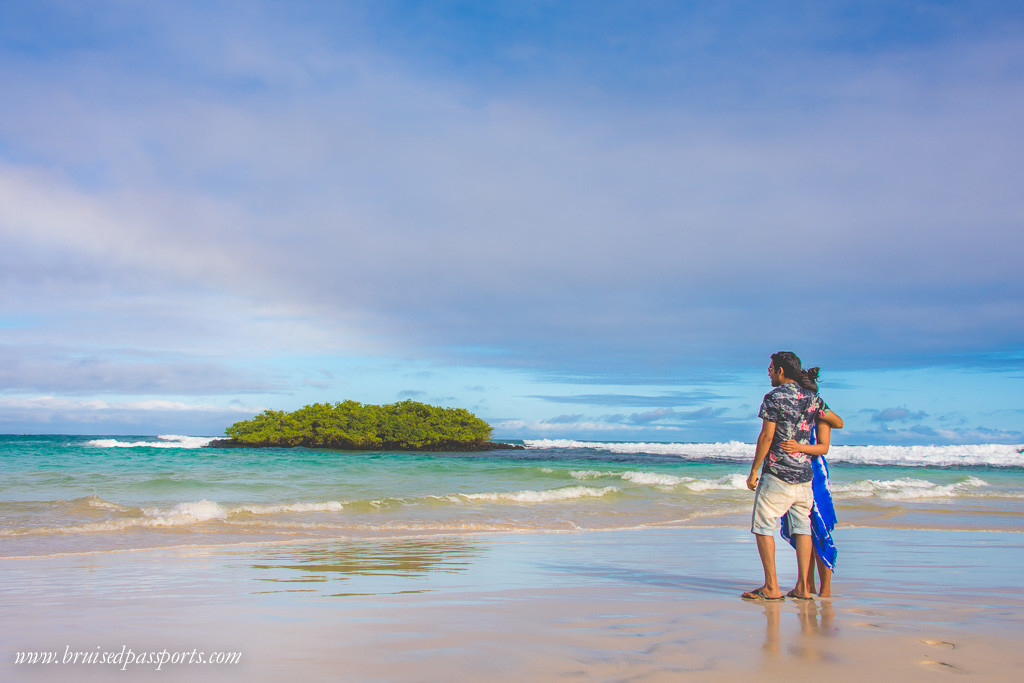 Couple on the beach at tortuga bay Galapagos