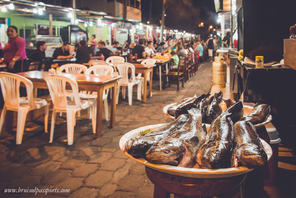 street in Puerta Ayora with kiosks and food stalls at night