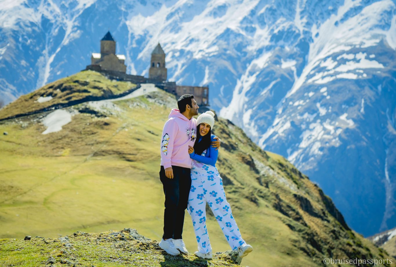 Couple at Gergeti trinity church in Kazbegi