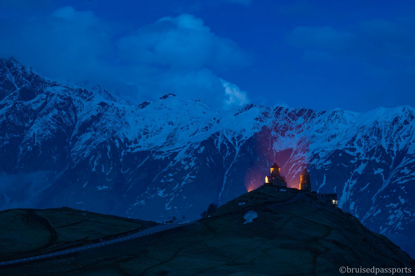 Gergeti trinity church at dusk with light