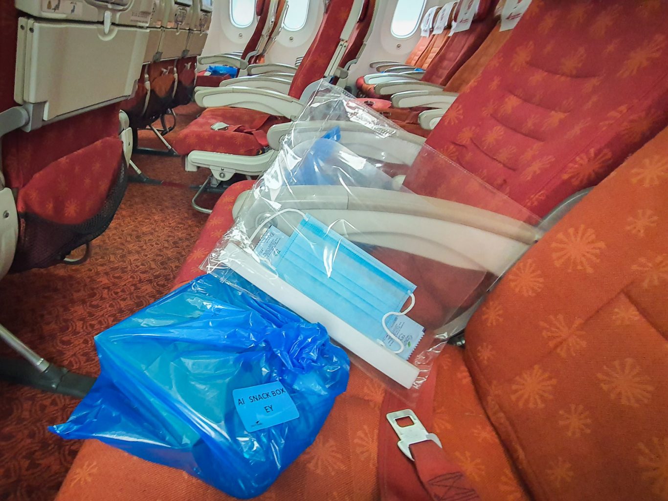 Pre-packed snack boxes, masks, visor, and hand sanitiser on flight