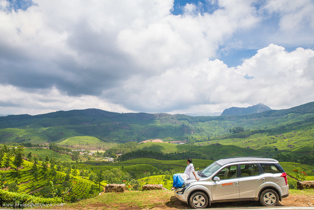 Boy on car in road trip of Kerala