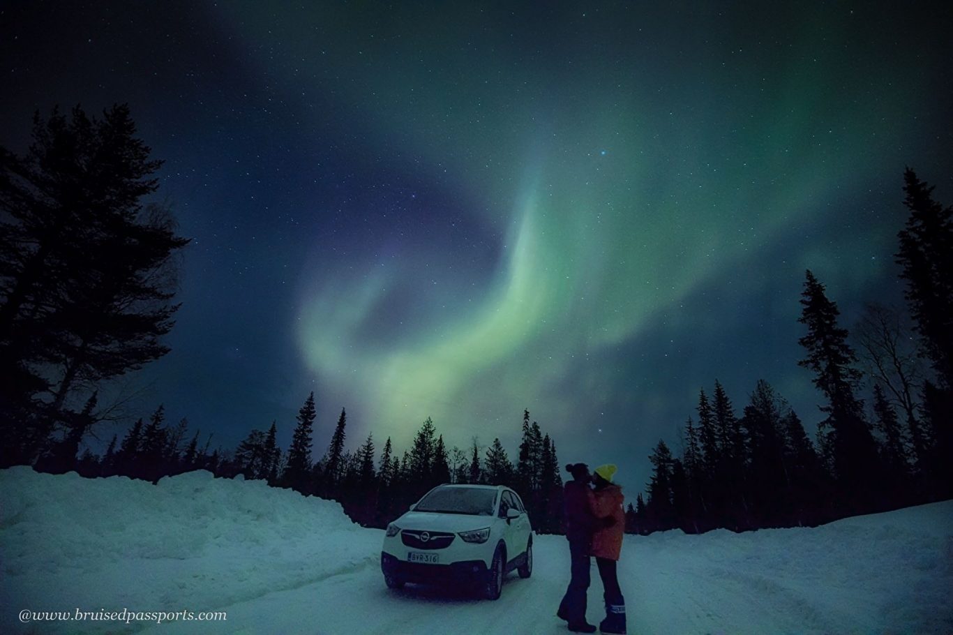 Couple under Northern Lights in Lapland Finland