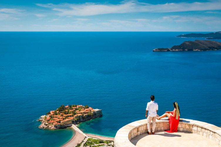 couple at Blizikuce church at vantage point of Sveti Stefan