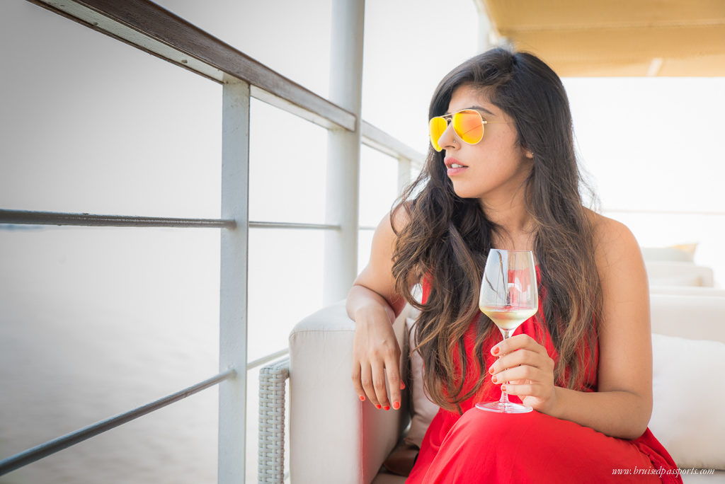 girl sipping wine on river cruise Myanmar