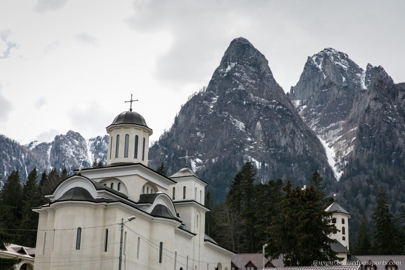 busteni monastery with towering mountains at the back