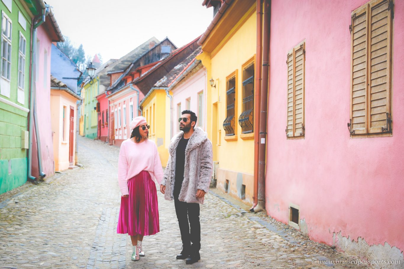 Couple in medieval city of Sighisoara in Romania