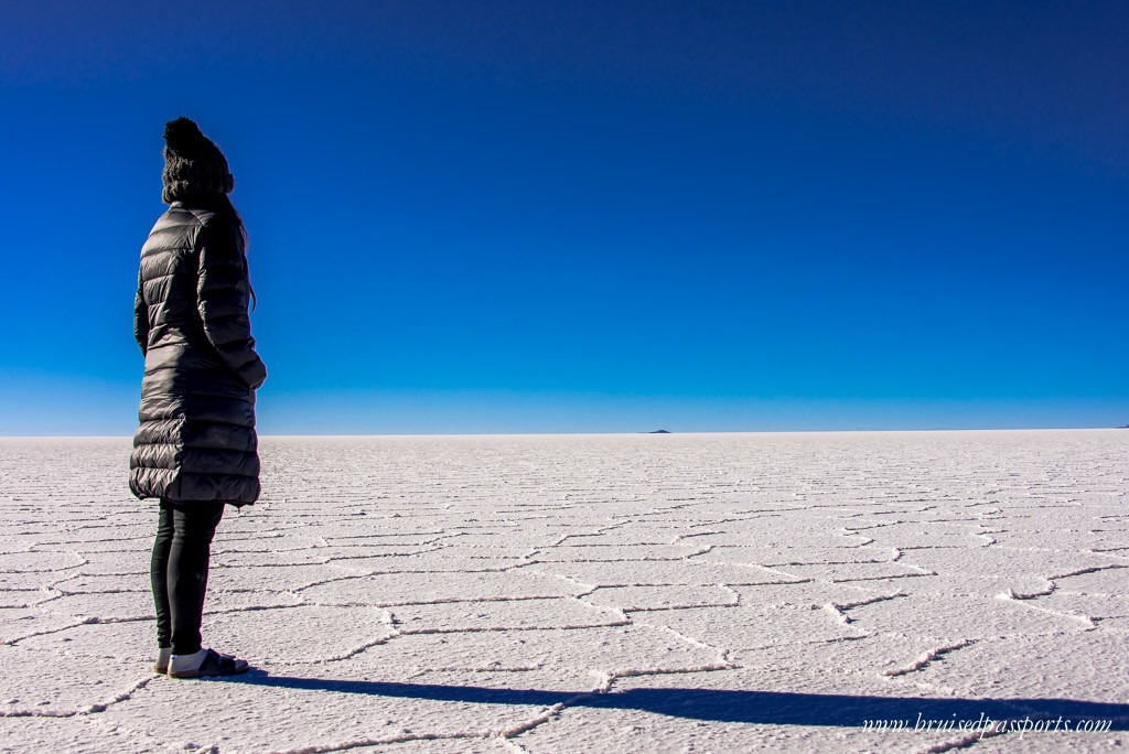 Girl standing in the middle of Salar De Uyuni Bolivia