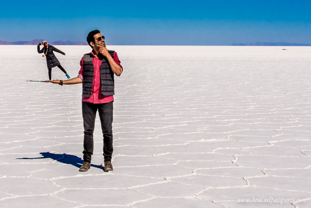 A couple doing perspective shots in Salar De Uyuni Bolivia