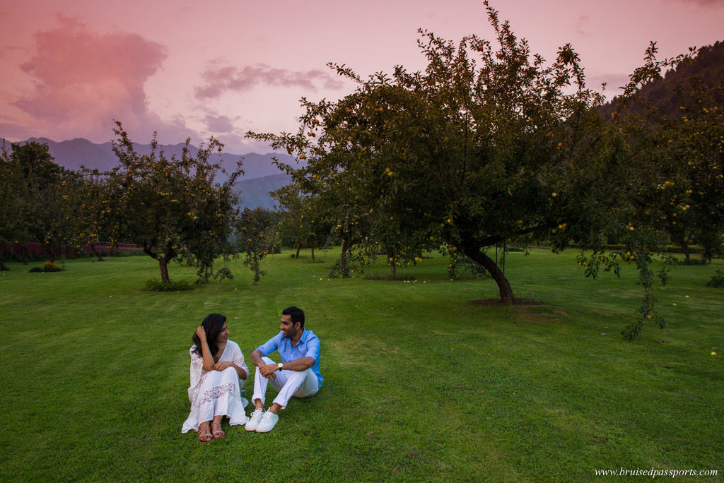 Couple sitting in apple orchards in Srinagar