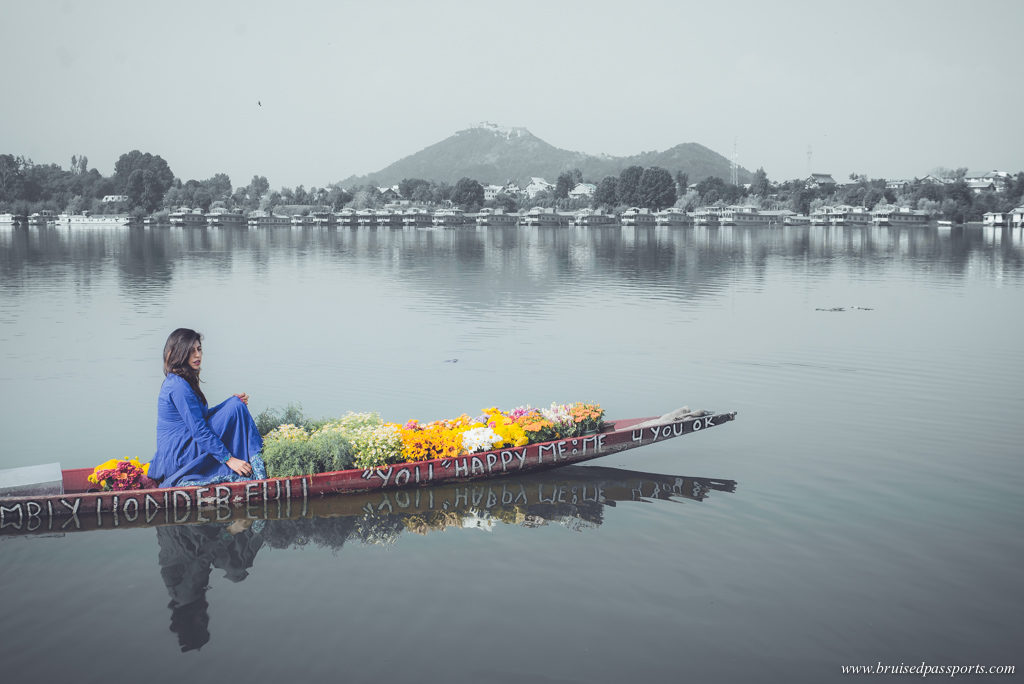 Girl in a shikara full of flowers in Nigeen Lake Srinagar