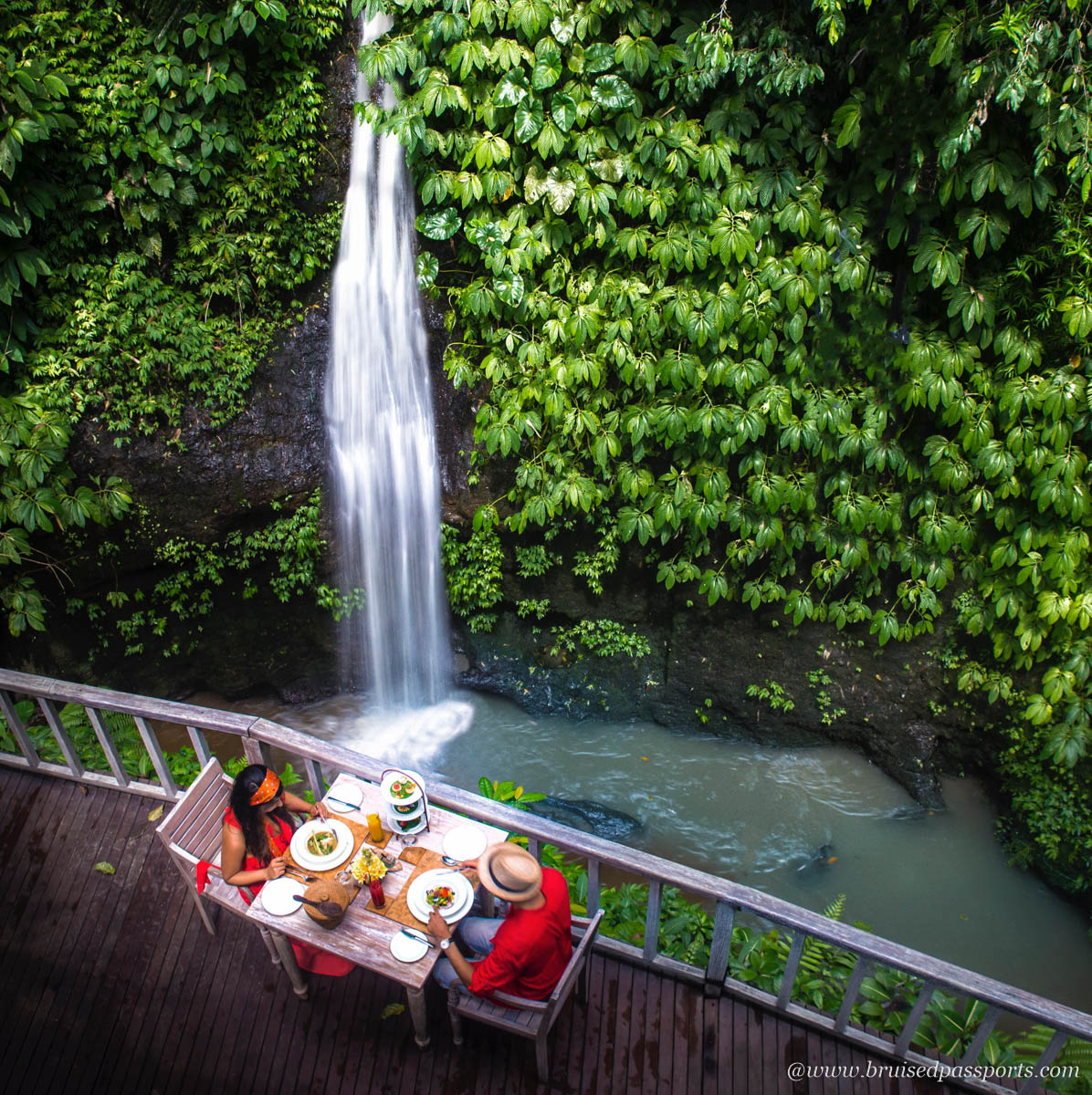 Couple dining by a private waterfall in Bali