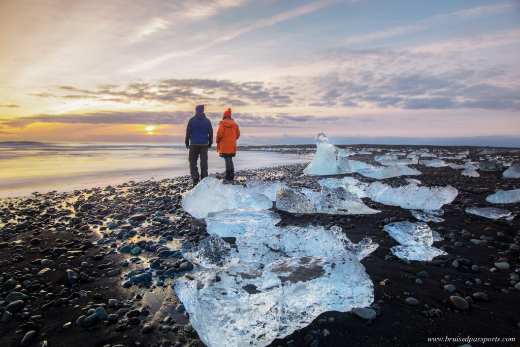 couple enjoying sunrise at Diamond beach near Jokulsarlon